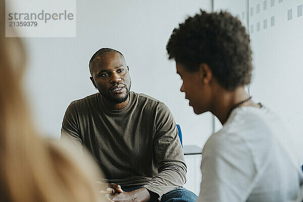 Mental health professional guiding student in high school