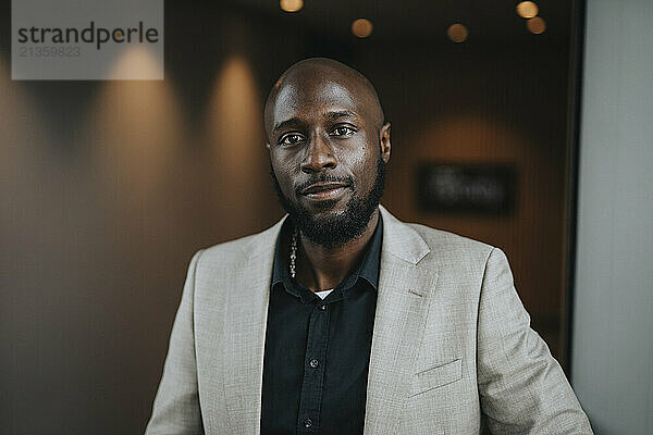 Portrait of confident mature bald male professional in businesswear