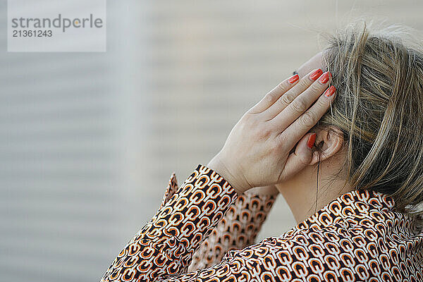 Woman covering her face with her hand. Depression.