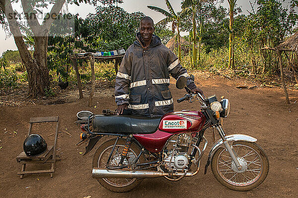 Loan officer of Encot microfiance institution on his way to visit customers in a remote village  Western region  Uganda.