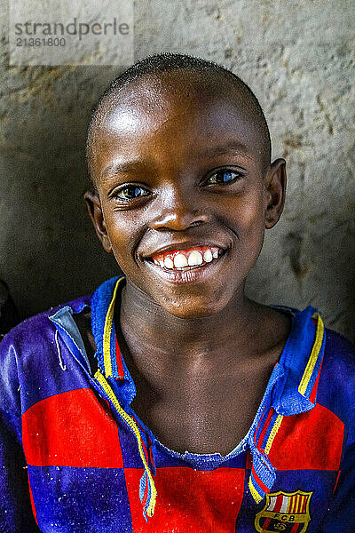 Smiling boy sitting in a home in southern Rwanda