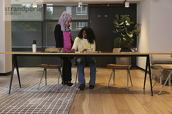 Two businesswomen discussing in office