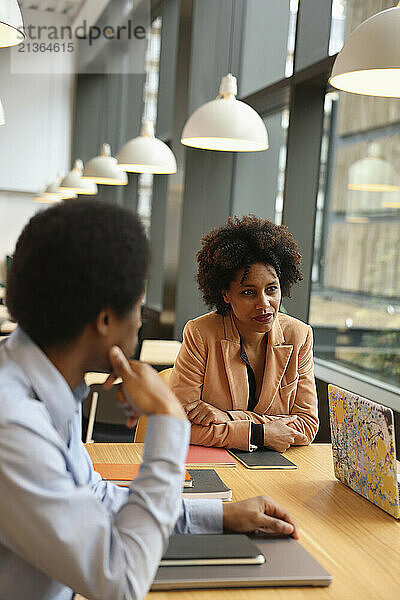 Businessman and businesswoman sitting in office