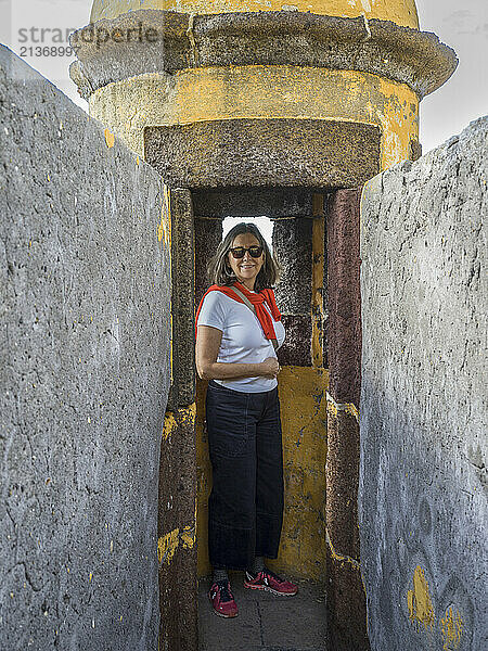 Female tourist at the Fort of Sao Tiago in the coastal town of Funchal  on the island of Madeira  Portugal; Funchal  Madeira  Portugal