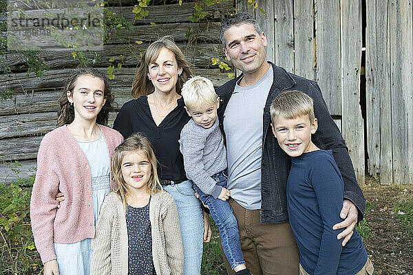 Portrait of a family standing in front of a wooden building in Beckwith Township at Carleton Place in the Ottawa Valley; Ontario  Canada