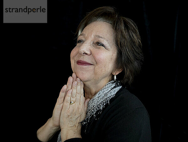 Portrait of a senior woman with a delighted expression; Studio