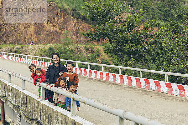 Women with their children posing along a road in Vietnam; Nam Pam  Muong La District  Son La  Vietnam