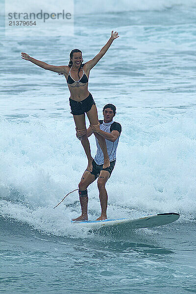 Tandem surfers in a surf competition at Makaha Beach on the island of Oahu  Hawaii  USA; Makaha  Oahu  Hawaii  United States of America