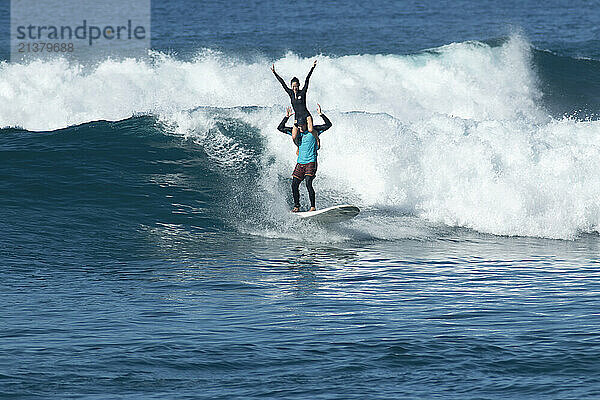 Tandem surfers in a surf competition off the island of Oahu  Hawaii  USA; Makaha  Oahu  Hawaii  United States of America