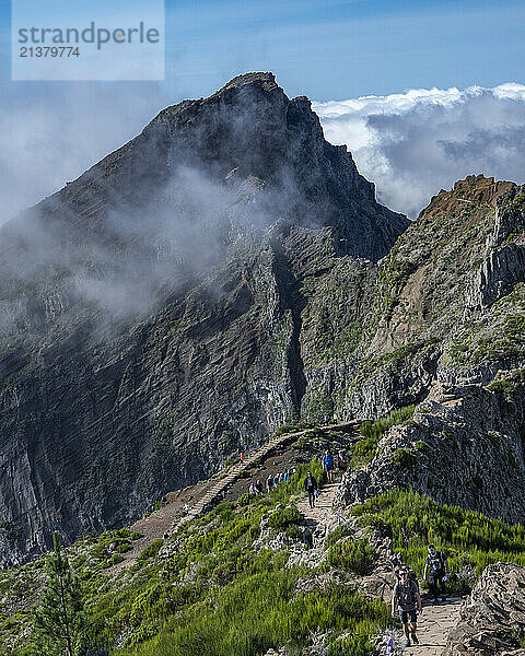 Hikers on the trail on Pico do Areeiro  Madeira island's third highest peak  Portugal; Sao Roque do Faial  Madeira  Portugal