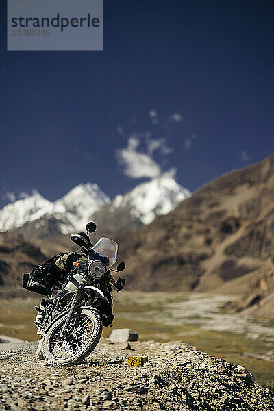 Motorcyle parks on a gravel roadside in the Himalayas near Dhar Makpachhe  Himachal Pradesh  India; Himachal Pradesh  India