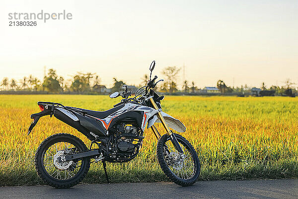 Motorbike parked on the side of a road in the countryside in South Sulawesi  Indonesia; Rammang-Rammang  Bontoa  Maros Regency  South Sulawesi  Indonesia