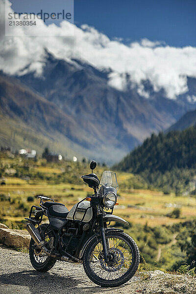 Motorcycle parked on a roadside in the Western Himalayas of Northern India; Chitkul  Himachal Pradesh  India