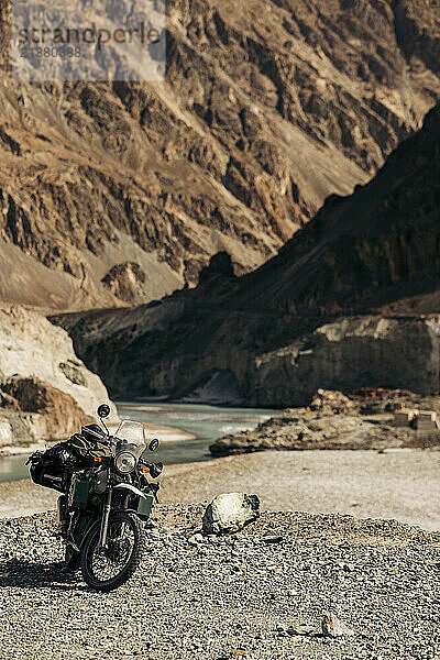 Motorcycle parked in a river valley along the Diskit-Turtuk Highway in Ladakh  India; Ladakh  India