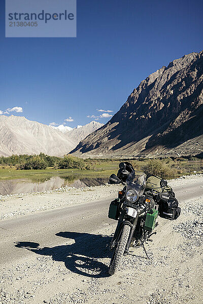 Motorcycle parked on a roadside in Nubra Valley; Leh  Ladakh  India