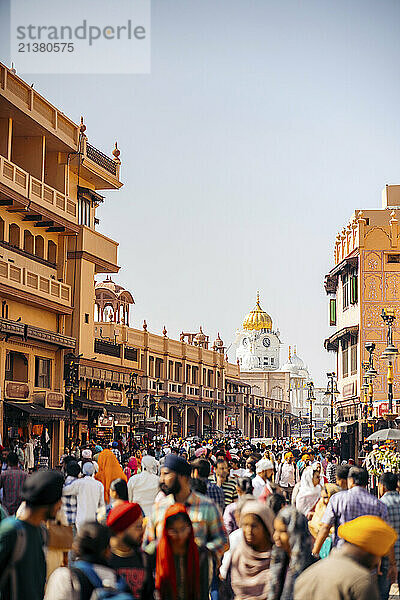 Busy street full of pedestrians and a view of the Golden Temple in the distance in the city of Amritsar  India; Amritsar  Punjab  India