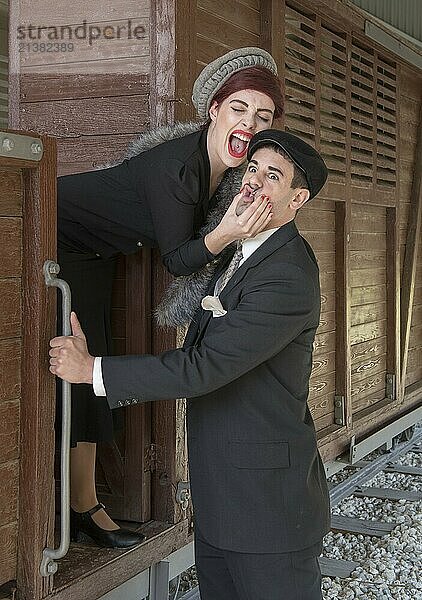 Young happy beautiful couple having fun  playing and laughing on a train