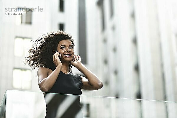 Happy smiling afroamerican woman have a nice conversation at street