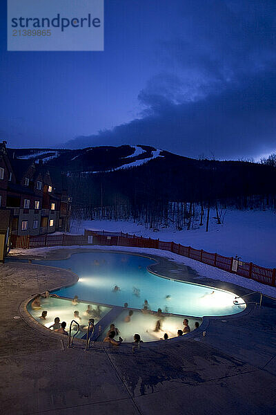 Skiers relax in a heated pool and hot tub at The Jordan Grand Hotel at Sunday River ski resort in Bethel  Maine.