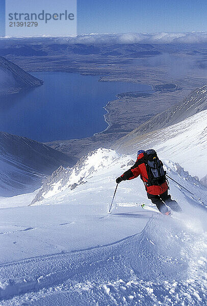 Skier (male) making turns at Ohau Skifield in Southern Alps of South Island  New Zealand - Mike Richards.