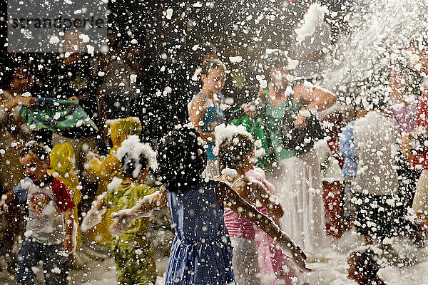 Children enjoy fake snow (foam) as part of the holiday festivities at the Tanglin shopping mall in Singapore. Singapore has been quick to embrace certain western values during the countries short history.