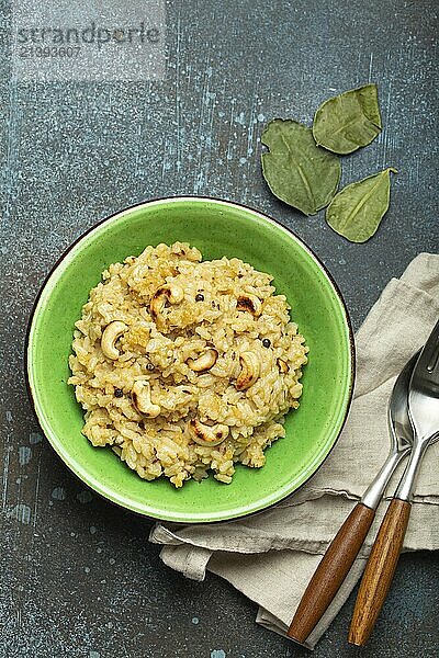 Ven Pongal (Khara Pongal)  traditional Indian savoury rice dish made during celebrating Pongal festival  served in bowl top view on concrete rustic background  food photography  food photography