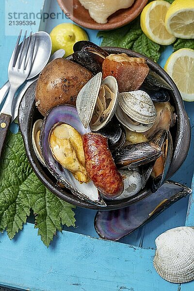 Food  Food  Famous traditional dish of the south of Chile and the Chiloe archipelago  Curanto Kuranto. Different seafood and meat cooked in a pit on the coals under the ground