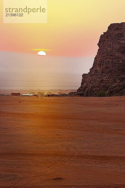 Jordan  Wadi Rum sun appears over horizon  sunrise in the desert  camp tents  Asia