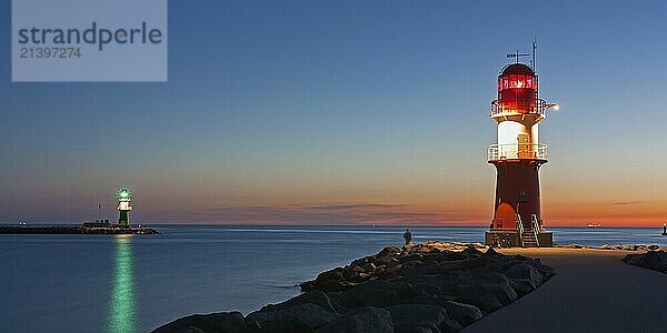 Lighthouses (pier lights) at the harbour entrance of Rostock-Warnemünde at night in Mecklenburg-Vorpommern  Germany at the Baltic Sea. There is still some sunset on the horizon. Lighthouse (pier light) at the harbour entrance of Rostock-Warnemünde at sunset  Mecklenburg-Vorpommern  Germany  Baltic Sea  Europe