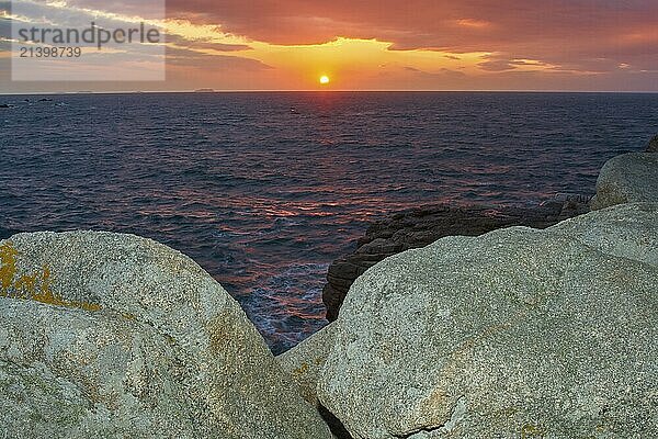 Sunset over the sea with rocks in the foreground and a colourful sky  Bratagne  France  Europe