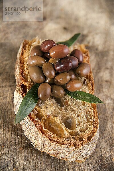 Snack of slice of bread with olives in brine