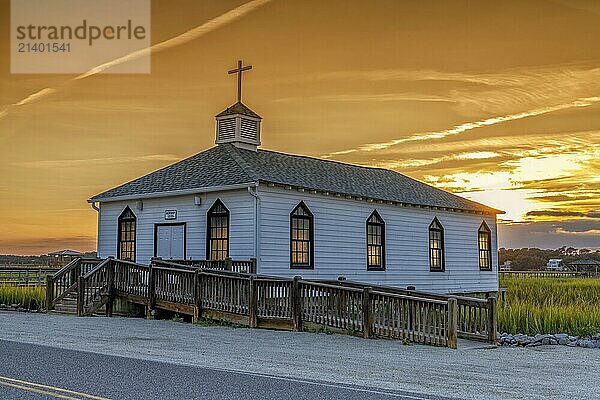 View of the historic Pawleys Island Chapel on the marsh at sunset