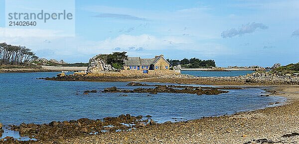 A stone house on a small island surrounded by calm water and rocks  house on the Plage de Raluzet  Plougrescant  Côtes-d'Armor  English Channel  Brittany  France  Europe