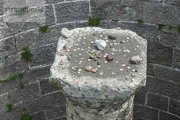 A picture of coins thrown by tourists on top of a column at the Pergamon Ancient City