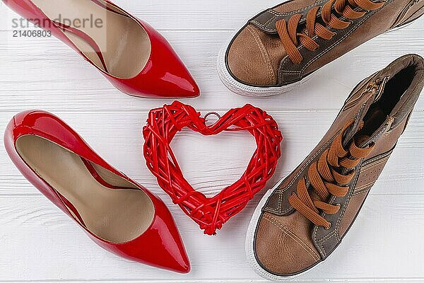 Top view of mens and womens shoes on white desk. Love or marriage concept