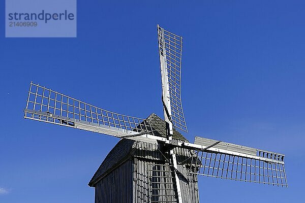 Windmill with wooden sails under a clear blue sky  traditional rural structure  borken  münsterland  germany