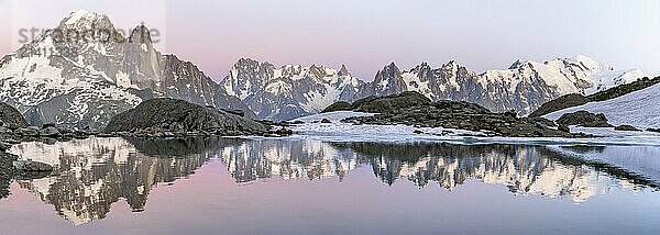 Evening mood with pink evening sky  mountain landscape at sunset  water reflection in Lac Blanc  mountain peaks Aiguille Verte  Grandes Jorasses and Mont Blanc of the Mont Blanc massif  Chamonix-Mont-Blanc  Haute-Savoie  France  Europe