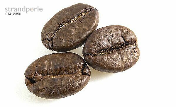 3 coffee beans on a white background. Arabica isolated close up