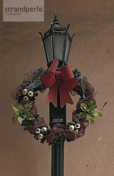 Decorated with a flower wreath old street lamp in casco viejo panama city