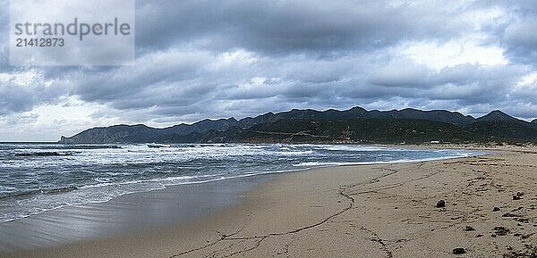 A panorama landscape of Plagemesu Beach and rugged Sardinian coast under a stormy and overcast sky