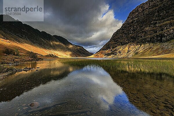 Mountains reflected in lake  evening light  cloudy mood  autumn  Loch Achtriochtan  Glencoe  Scottish Highlands  Scotland  Great Britain