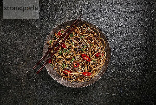 Udon noodles  with shimeji mushrooms  vegetables  in sauce  with sesame seeds  green onions  Asian vegetarian food  horizontal  without people