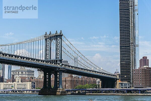 New York City  USA  June 24  2018: Manhattan Bridge and cityscape from East River. Iconic view of NYC  North America