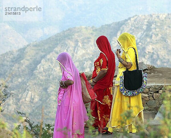 Indian women in colorful saris looking from top of hill