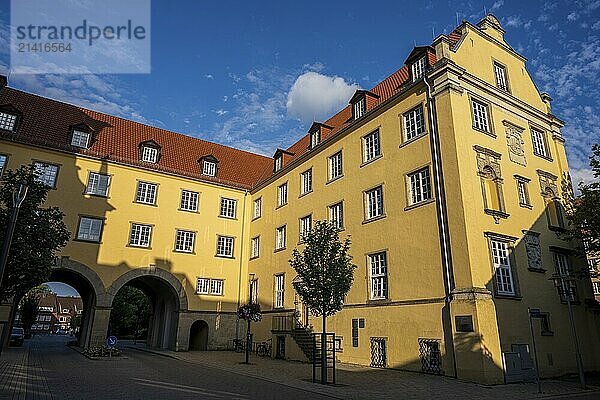 A large  historic building with a yellow façade and dormer windows under a clear sky  former town castle in Coesfeld  Münsterland