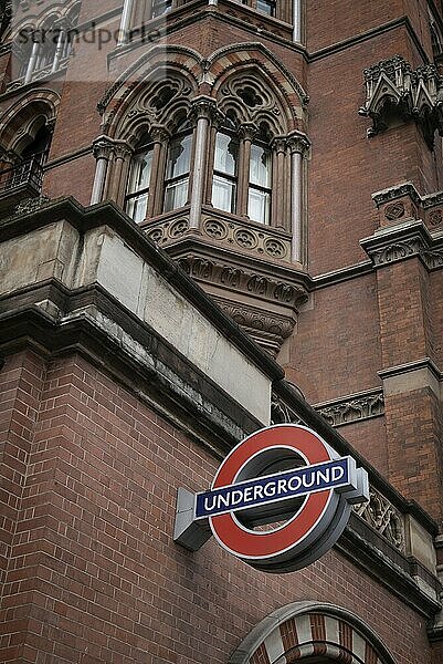 London UK  July 02 2019: St Prancras london underground station and red underground sign on the building against cloudy sky