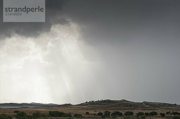 Sunrays coming out of the clouds on a winter cloudy day with dramatic stormy sky