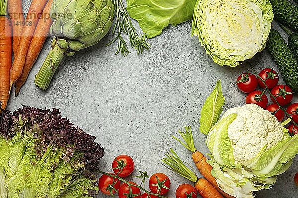 Fresh various organic vegetables on rustic grey stone table top view with copy space. Vegetarian food background and healthy vegetable ingredients with vitamins concept  diet and clean eating  food photography  food photography