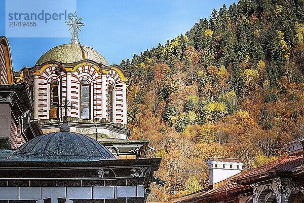 Rila monastery  Bulgaria church dome and cross close-up and autumn mountain trees at background