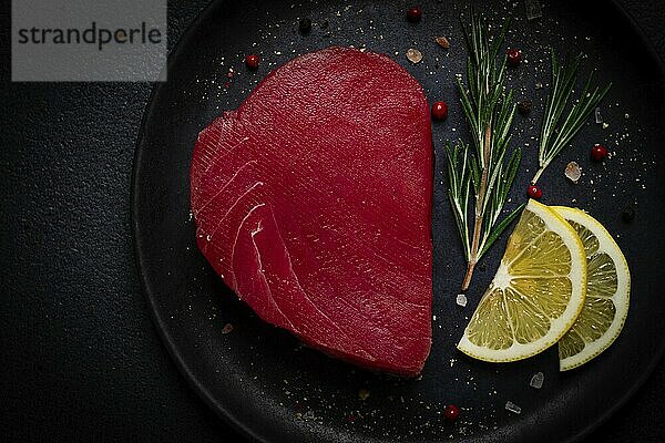 Fresh red tuna fillet  for steak  raw  top view  on a black plate  no people